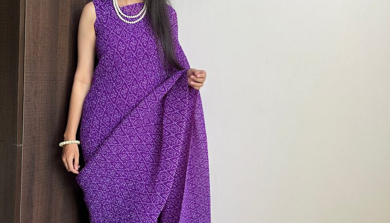 Embrace Effortless Elegance with the Purple Faux Georgette Saree Gown Featuring Bandhani Print